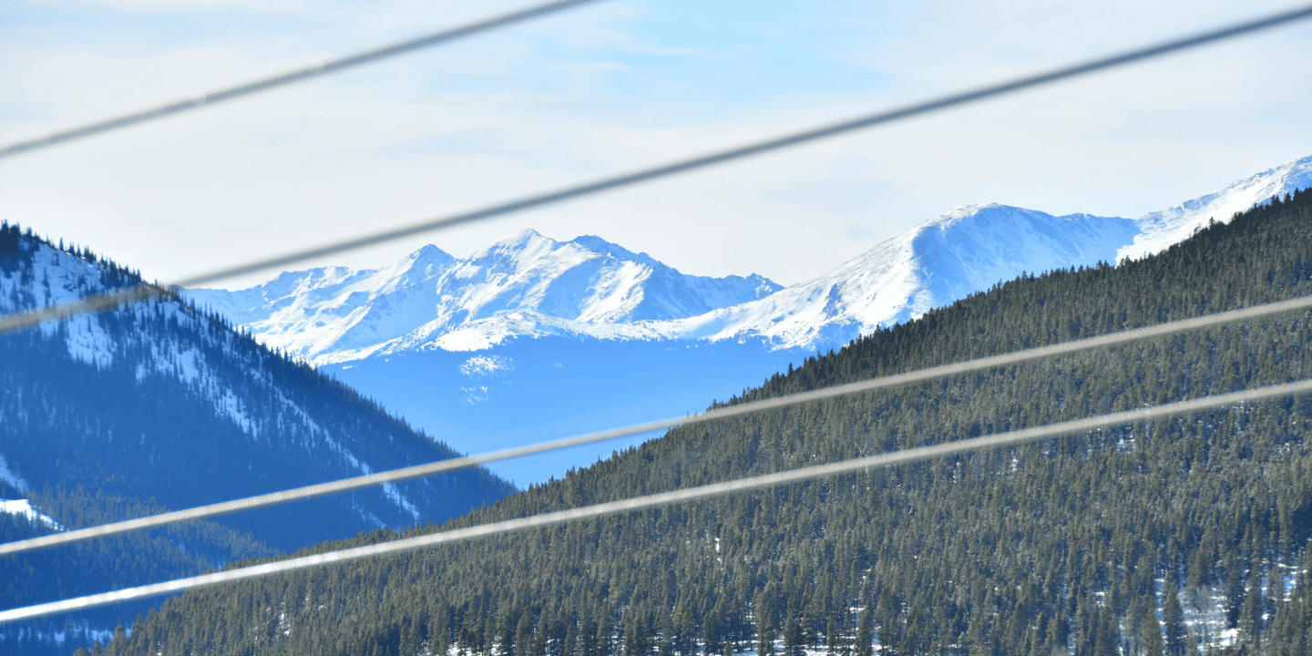 zip line wires with mountains and trees in the background