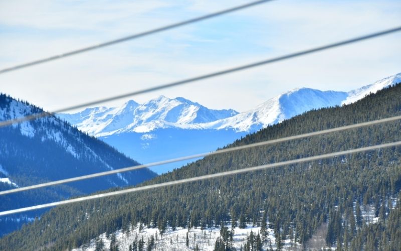 zip lines in foreground with mountains and trees behind